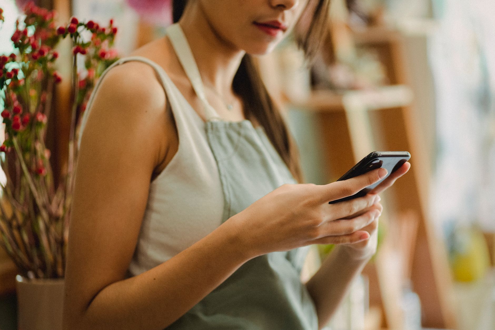 Small business owner checking customer messages on their phone